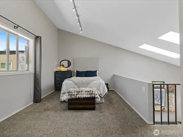 The lofted bedroom feels so big with the vaulted ceilings.