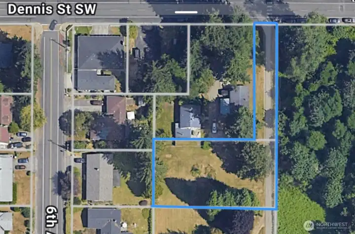 This lot owns the 30' wide entry from Dennis street with gravel drive.
