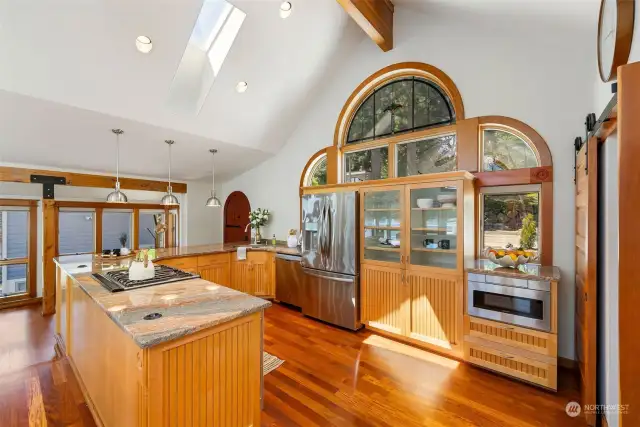 Stainglass windows flank the vaulted ceilings in main living room.