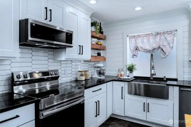 Full height picket style tile blends seamlessly with shiplap accent wall to create multi-textured and interesting background without being too busy. Add custom built reclaimed wood shelves and you have the perfect touch of warmth in this beautiful kitchen.