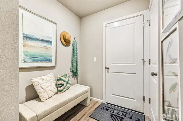 Mudroom from garage enters into living room-Disclaimer- Photos are of another Finley floor plan from a previous community, photos are for illustrative purposes only. Finishes, flooring, upgrades, or other features may vary.