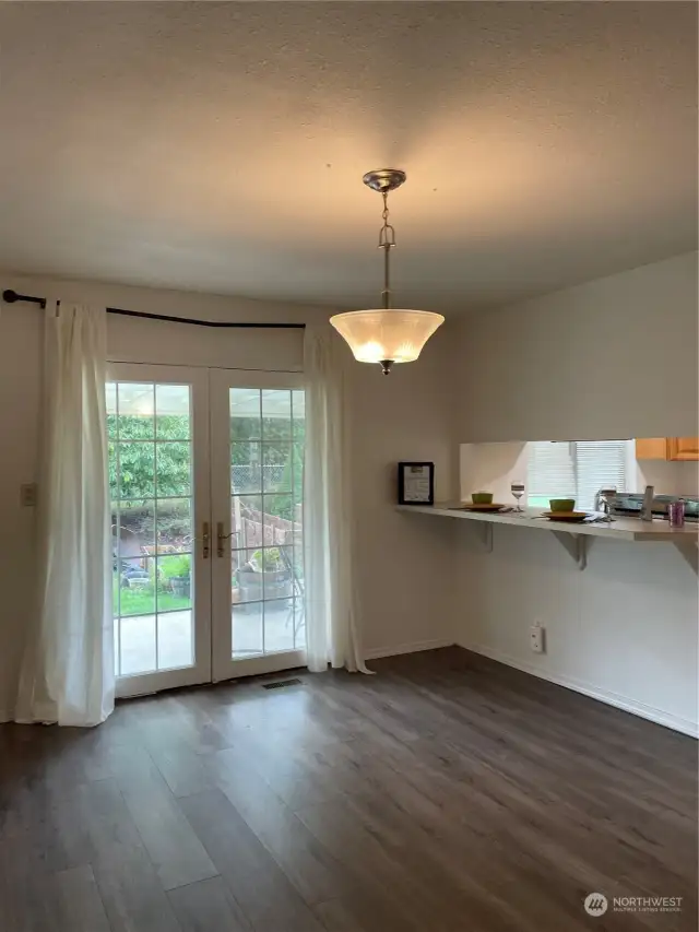 Get formal with a large dining area covered in updated LVT flooring, that overlooks the backyard from a set of French doors.