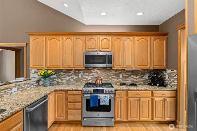 Easy flowing kitchen with stainless steel appliances.