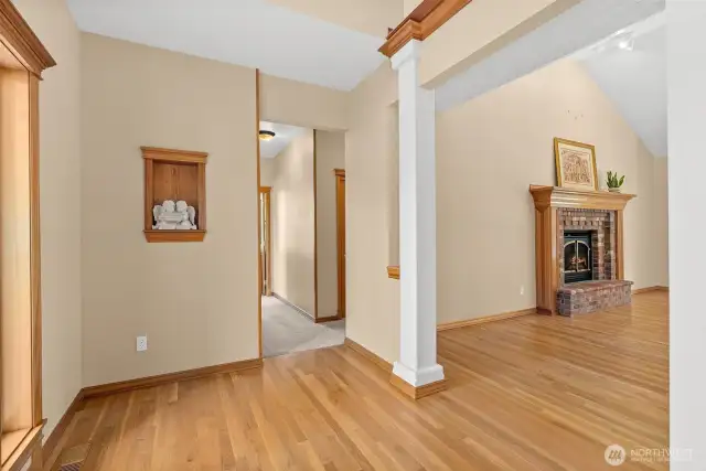To the left it takes you to the left wing where you will find three bedrooms plus 1.75 baths.  Not including the master bedroom which is on the other side of home. Straight ahead is the open great room area.