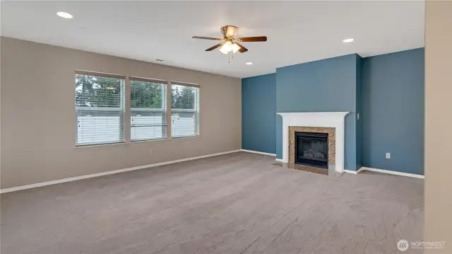Spacious family room with gas fireplace and granite surround and craftsman mantle