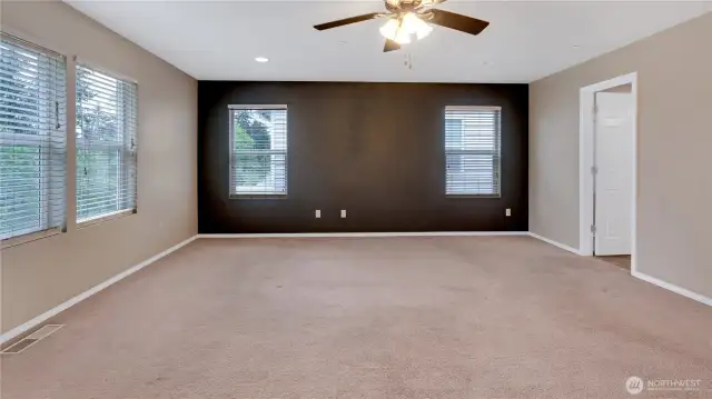 Angle of the primary suite showing door to primary bathroom