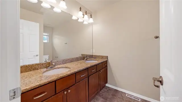Full bath with dual vanities conveniently located near the 3 additional bedrooms upstairs.