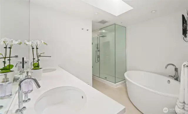 The luxurious primary bathroom features a soaking tub, walk-in shower and heated floors.