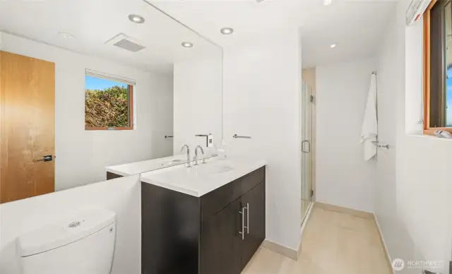 The ensuite bath for bedroom #3 on the lower level. Also with heated floors.