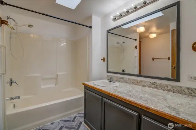 Nice laminate flooring and tub/shower combo.