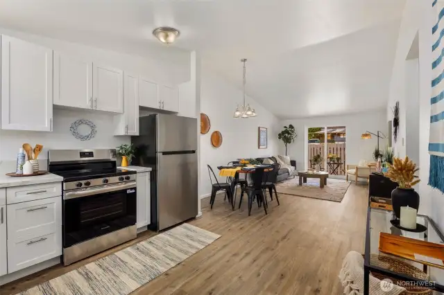 Spacious great room floor plan with new sliding doors leading to private patio and partially fenced yard.