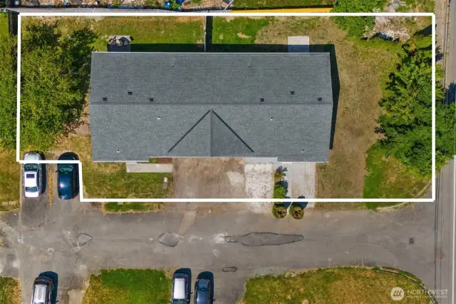 Aerial showing approximate property boundaries. There are 4 parking spaces in front of duplex plus 2 carports