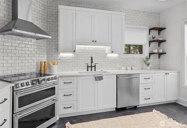 Renovated kitchen has induction cooking.