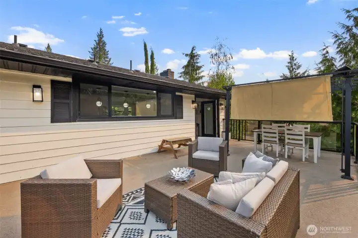 Expansive view deck with waterproof decking, offering both dining and lounging space for effortless indoor-outdoor living. A sleek modern porch light adds a touch of magic in the evenings, making this the perfect spot to enjoy lake views from sunrise to sunset.