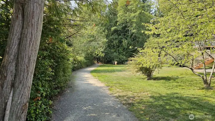 Just down the trail to the west, a little free library awaits your next discovery — the perfect stop on an afternoon stroll through the neighborhood.