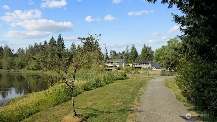 A feeling of peace enfolds you as you see your home appear at the end of a lakeside walk. No need for cars or streets, just the simple joy of stepping from trail to door. This serene eastern approach makes everyday living feel like a sanctuary.