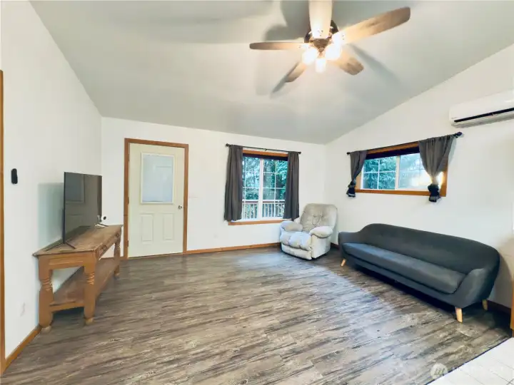 Living room: PLV flooring, mini-split, door to deck with views of the Columbia River and the 5+ acres