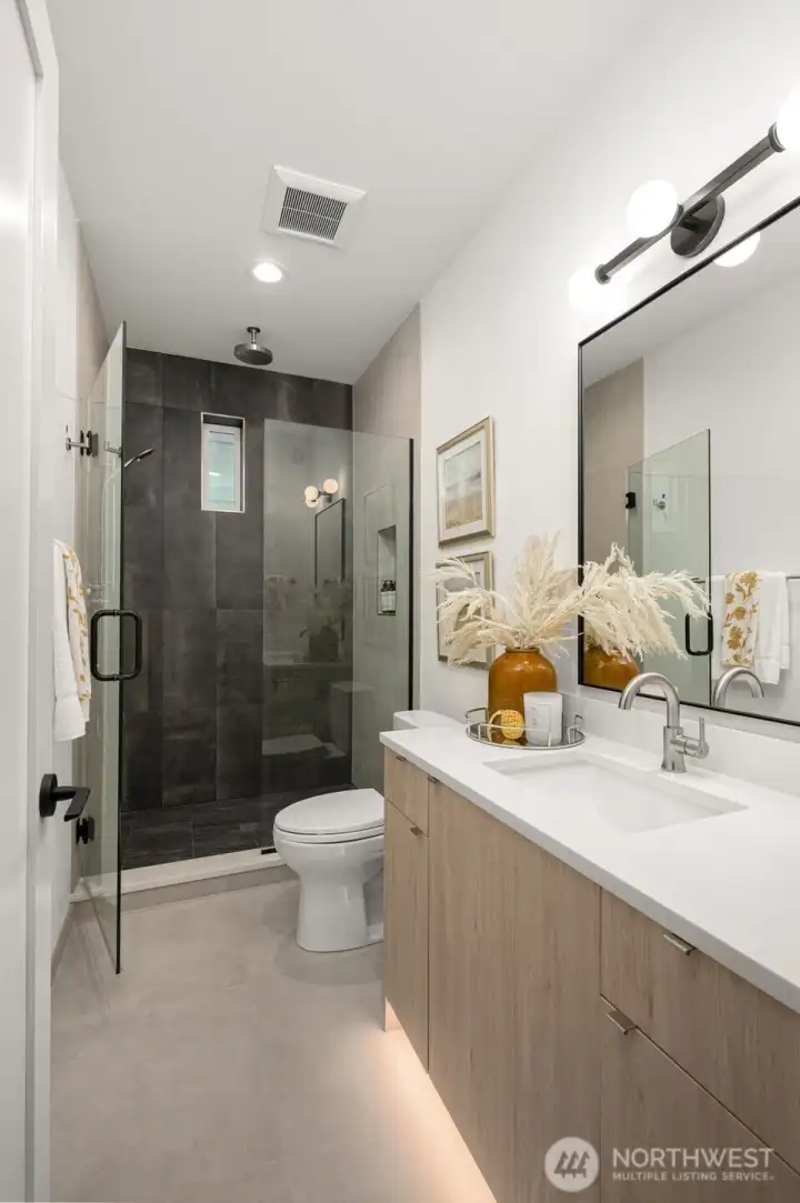 Spa-like ensuite bath with dual sinks, walk-in shower, and contemporary finishes.