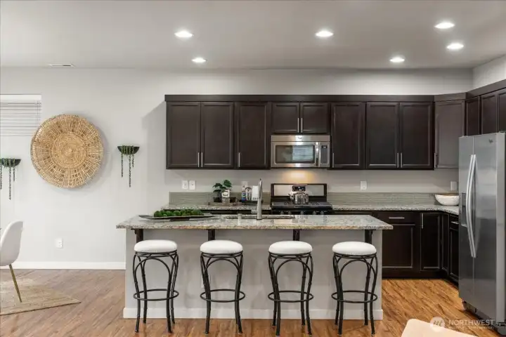Gorgeous kitchen with granite countertops, stainless steel appliances, pantry, and abundant cabinetry.