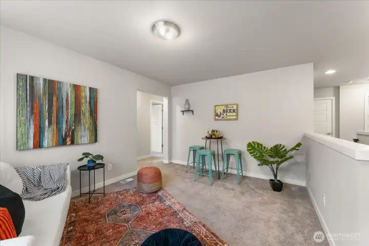 Versatile upstairs loft provides flexible space for a media room, home office, or play area.