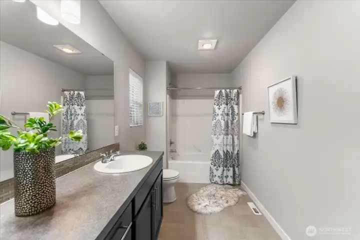 A spacious and well appointed full bathroom upstairs.