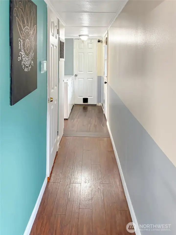 Hallway leading to laundry, second bedroom and full bathroom.