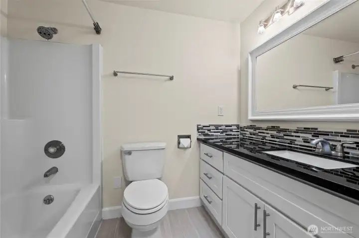 Remodeled bathroom with gorgeous counters and custom backspash
