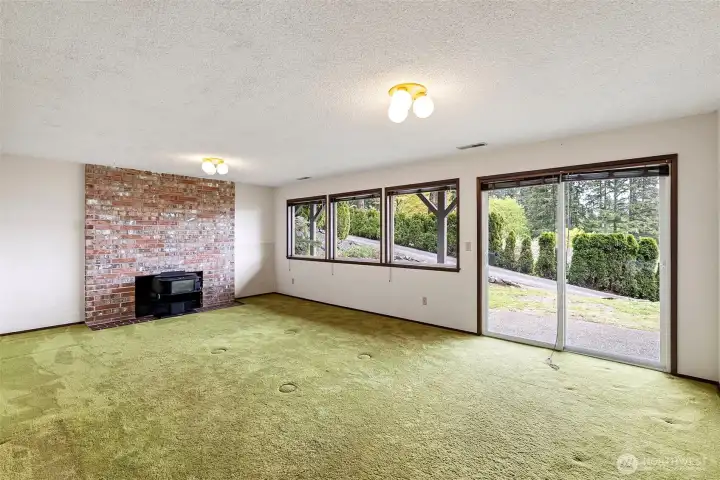 The lower level enjoys this large rec room with slider to the patio. A wood burning fireplace keeps this space cozy, when needed.