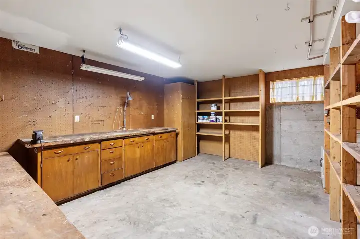 The lower level includes this work shop/hobby space with built-in shelving and cabinetry.