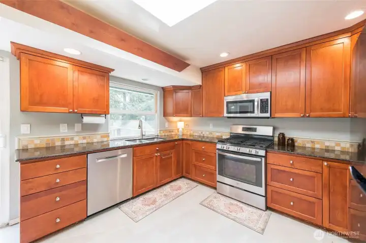 Updated kitchen with new tile flooring and plenty of counterspace for cooking.