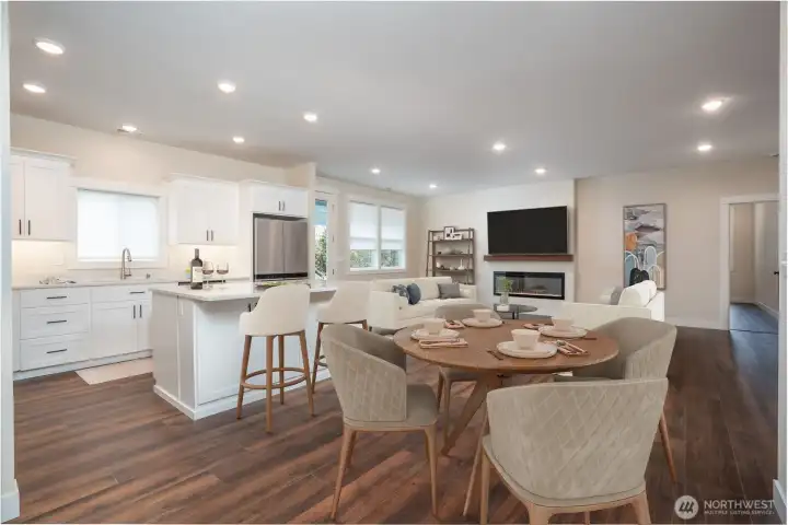 Second view of the great room from the kitchen end. Love the island witheating counter.  Virtually staged.