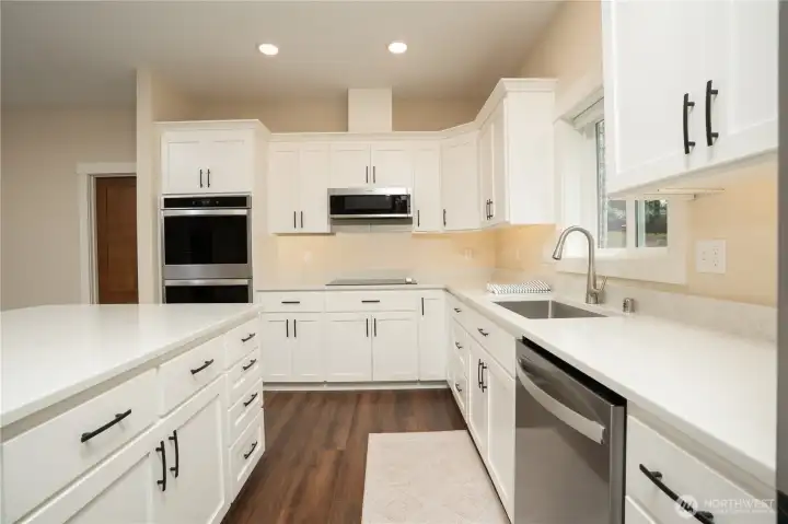 Plenty of room for two chefs with this amount of quartz counter space.  Also a walk-in pantry.