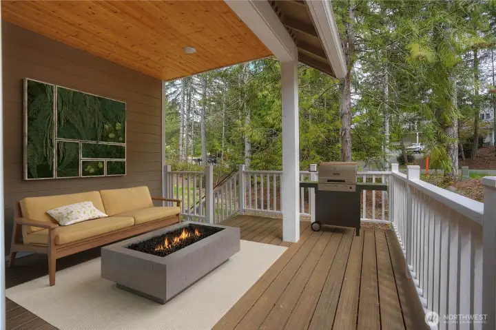Quiet deck on the corner of the home with landscaping wrapping edge of the lot for privacy.  Virtually staged.
