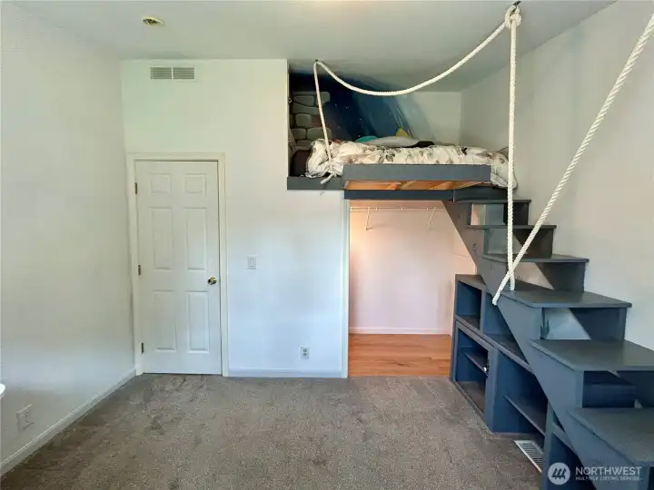 Bedroom number two showing sleeping loft over the closet with built-in storage