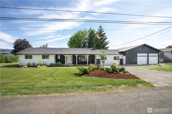 Tons of parking in extra-long driveway and extended gravel driveway in front of shop