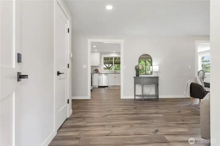 Come on in! Warm-toned LVP flooring throughout entire home