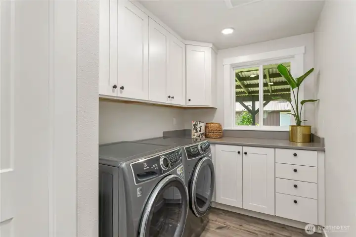 Just across hall from full bathroom is large utility room (w/d included) with tons of cabinets, closet, counter space & window