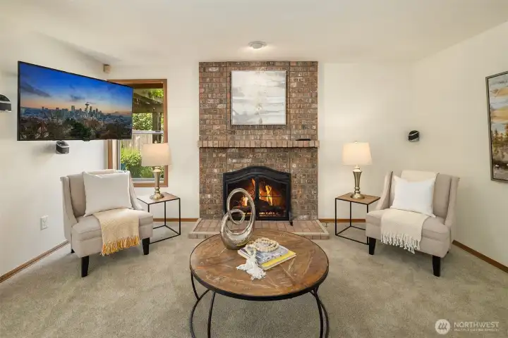 A nice family room with fireplace and wall mounted TV and speakers included if buyer wants them!