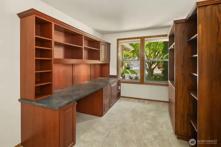 The Den on the main level that features built in desk area to the left / Book shelves on the right side can  be removed and are not attached to the walls