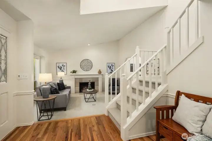 A lovely front entry way with double front doors & lead glass windows, rich hardwood floors, and a large skylight keeps the the house filled with natural light!