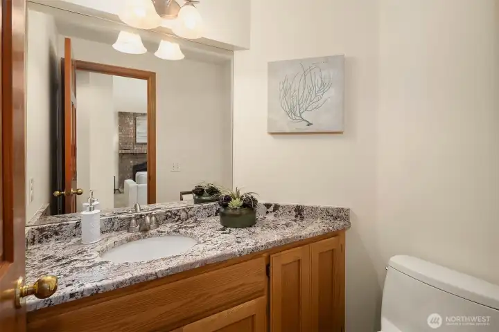 The main level powder room with updated granite counter top