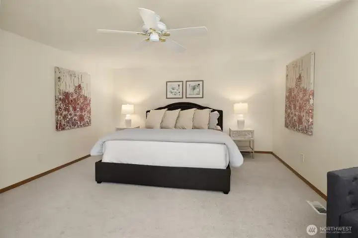 The primary bedroom suite with new carpet & paint