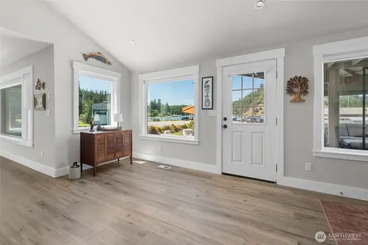 Front door entrance into the open concept kitchen, dining, and living rooms