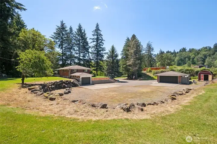 View of home, parking, and detached 2 car garage looking SW