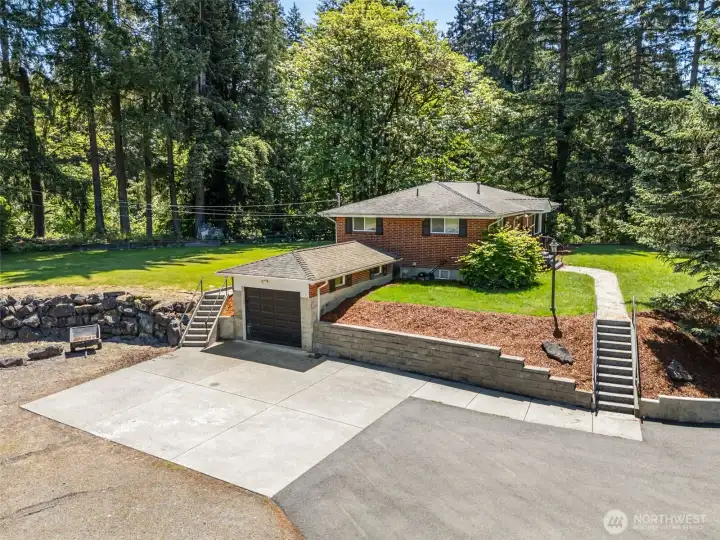 Drone view of home looking SE including 2 car garage