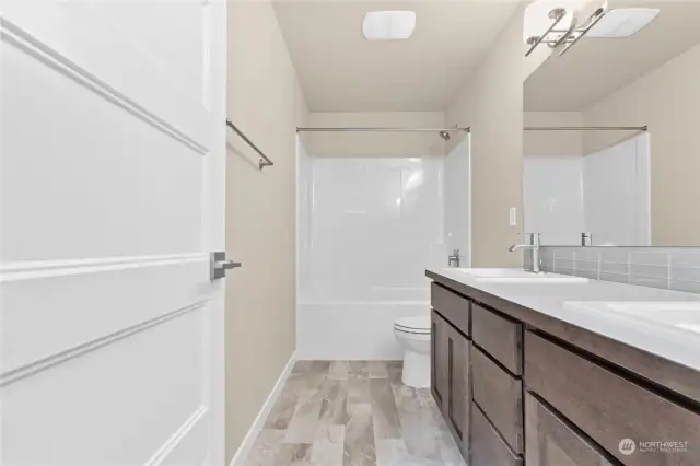 Similar home, not actual. Main bathroom with double sinks.