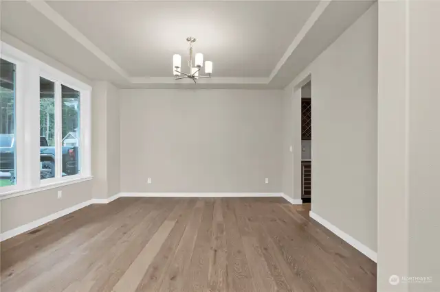 Similar home, not actual. Formal dining area with tray ceiling.