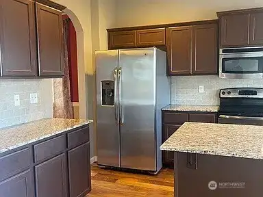 Storage Solutions & Style: A Kitchen with Room for Everything, Leading to a Distinct Dining Area.