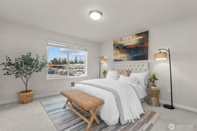 Spacious primary bedroom with peaceful natural light.