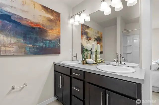 Primary ensuite bath features double vanity, modern fixtures, and a large shower/tub combo.